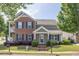 Inviting two-story home with brick and siding, features manicured landscaping and an appealing facade at 577 Cypher Drive, Suwanee, GA 30024