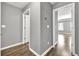 Bright hallway boasts wood-look flooring and neutral gray walls, leading to inviting rooms at 577 Cypher Drive, Suwanee, GA 30024