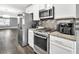 Modern kitchen with stainless steel appliances, granite countertops, and sleek backsplash at 577 Cypher Drive, Suwanee, GA 30024