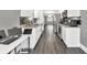 Modern kitchen with stainless steel appliances, white cabinets, and a spacious workspace at 577 Cypher Drive, Suwanee, GA 30024