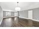 Open living area featuring hardwood floors, neutral paint, and plenty of natural light at 577 Cypher Drive, Suwanee, GA 30024