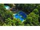 An aerial view of the community tennis courts and pool nestled among lush greenery and mature trees at 63 Lewellen Dr, Marietta, GA 30064