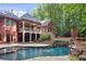 Beautiful backyard featuring a swimming pool with waterfall and spacious outdoor living areas at 63 Lewellen Dr, Marietta, GA 30064