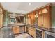 Finished basement bar area with wood cabinets, stainless steel appliances, and view to the stairs at 63 Lewellen Dr, Marietta, GA 30064