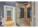 Stylish bathroom featuring a glass shower with tile accents and a view into the hallway at 63 Lewellen Dr, Marietta, GA 30064