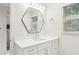 Bathroom featuring a geometric mirror and a vanity with white cabinetry at 63 Lewellen Dr, Marietta, GA 30064