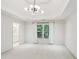 Bright bedroom with neutral carpet, modern light fixture, and a view of a bathroom at 63 Lewellen Dr, Marietta, GA 30064