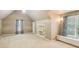Large bonus room with sloped ceilings, built-in shelves, and window seat at 63 Lewellen Dr, Marietta, GA 30064