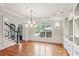 Formal dining room featuring hardwood floors, statement chandelier, large window, and built-in shelves, ideal for entertaining at 63 Lewellen Dr, Marietta, GA 30064