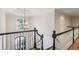 Elegant foyer with dark wood railing, white spindles, large window, and chandelier at 63 Lewellen Dr, Marietta, GA 30064