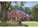 Stunning brick home with mature landscaping, black shutters, and a welcoming front entrance at 63 Lewellen Dr, Marietta, GA 30064