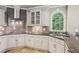 Close up of kitchen featuring gas cooktop, stainless vent hood, and gray subway tile backsplash at 63 Lewellen Dr, Marietta, GA 30064