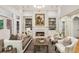 Inviting living room featuring a marble fireplace, built-in shelving, stylish furnishings and ample natural light at 63 Lewellen Dr, Marietta, GA 30064