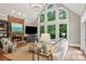 Living room featuring vaulted ceilings, stone fireplace and large windows with wooded views at 63 Lewellen Dr, Marietta, GA 30064