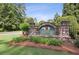 Stone monument sign for Sweet Pine Creek neighborhood framed by lush greenery and landscaping at 63 Lewellen Dr, Marietta, GA 30064