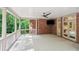 Covered porch with brick pillars, a ceiling fan, and an outdoor television screen at 63 Lewellen Dr, Marietta, GA 30064