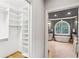 Organized walk-in closet with custom shelving next to a bathroom featuring a luxurious soaking tub at 63 Lewellen Dr, Marietta, GA 30064