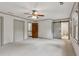 Spacious bedroom features plush carpet, natural light from two windows, neutral walls, and a ceiling fan at 9800 Woodfall Dr, Roswell, GA 30076