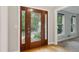 Elegant foyer featuring hardwood floors, a decorative front door, and neutral wall paint at 9800 Woodfall Dr, Roswell, GA 30076