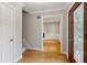 Inviting foyer with hardwood floors, neutral walls, stairs, and a glimpse of the living area at 9800 Woodfall Dr, Roswell, GA 30076