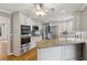 Modern kitchen with stainless steel appliances, granite countertops, and custom cabinetry at 9800 Woodfall Dr, Roswell, GA 30076
