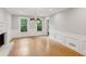 Elegant living room with hardwood floors, a chandelier, fireplace, and lots of natural light at 9800 Woodfall Dr, Roswell, GA 30076