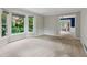 Bright living room with carpet floors, a bay window, and neutral color palette at 9800 Woodfall Dr, Roswell, GA 30076