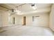 Large garage featuring white walls, multiple doors, and overhead lighting at 1211 Thornwell Dr, Brookhaven, GA 30319