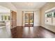Living room with hardwood floors, neutral paint, and french doors with access to patio at 1211 Thornwell Dr, Brookhaven, GA 30319