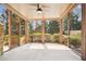Screened in porch with brick pillars, stained wood trim, and views of the landscaped yard at 1211 Thornwell Dr, Brookhaven, GA 30319
