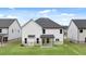 A rear view showing the ample backyard and a covered porch of a two story residence at 13567 Whitman Lane, Covington, GA 30014