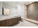 Elegant bathroom featuring a double sink vanity, walk-in shower with glass door, and modern fixtures at 3293 Lenox Ne Pl, Atlanta, GA 30324