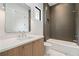 Modern bathroom with wood vanity, quartz countertop, and dark tile in shower at 3293 Lenox Ne Pl, Atlanta, GA 30324