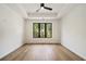This spacious bedroom features hardwood floors, tray ceiling, and large windows with forest views at 3293 Lenox Ne Pl, Atlanta, GA 30324