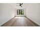 A modern bedroom with a large window and hardwood floors creates a serene and inviting space at 3293 Lenox Ne Pl, Atlanta, GA 30324