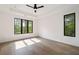 Bright bedroom with hardwood floors, large windows, and modern ceiling fan at 3293 Lenox Ne Pl, Atlanta, GA 30324