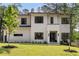 Striking modern home featuring a manicured lawn, elegant landscaping, and a sleek contemporary design at 3293 Lenox Ne Pl, Atlanta, GA 30324