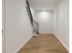 A bright hallway showcasing hardwood floors, a staircase with black railings, and neutral white walls at 3293 Lenox Ne Pl, Atlanta, GA 30324