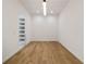 A well-lit hallway with wood floors and built-in shelving adjacent to the bathroom at 3293 Lenox Ne Pl, Atlanta, GA 30324