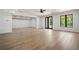 Large living room featuring hardwood floors, modern ceiling fan and ample natural light with black frame windows at 3293 Lenox Ne Pl, Atlanta, GA 30324