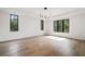 Bright living room featuring hardwood floors, large windows, and modern lighting fixture at 3293 Lenox Ne Pl, Atlanta, GA 30324