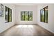 Bright living room featuring hardwood floors, large windows, and modern lighting fixture at 3293 Lenox Ne Pl, Atlanta, GA 30324