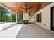 Covered patio features a ceiling fan, an outdoor fireplace, and stained wood ceiling at 3293 Lenox Ne Pl, Atlanta, GA 30324