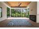 Covered patio featuring a wood ceiling, ceiling fan, fireplace, and view of backyard at 3293 Lenox Ne Pl, Atlanta, GA 30324