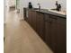 Stylish wet bar featuring dark wood cabinetry, sink, and sleek countertops at 3293 Lenox Ne Pl, Atlanta, GA 30324