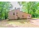 Side view of house, showing the backyard with trees and lawn at 3851 Natalie Way, Ellenwood, GA 30294