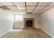 Cozy basement area featuring a fireplace with stone surround and neutral carpet at 3851 Natalie Way, Ellenwood, GA 30294