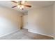 Bedroom featuring a ceiling fan, neutral carpeting, and a doorway leading to the bathroom at 3851 Natalie Way, Ellenwood, GA 30294