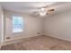 Bright bedroom features ceiling fan, large window for natural light, and neutral colored walls at 3851 Natalie Way, Ellenwood, GA 30294
