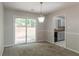 Cozy dining area with sliding glass doors to the backyard and an elegant light fixture at 3851 Natalie Way, Ellenwood, GA 30294